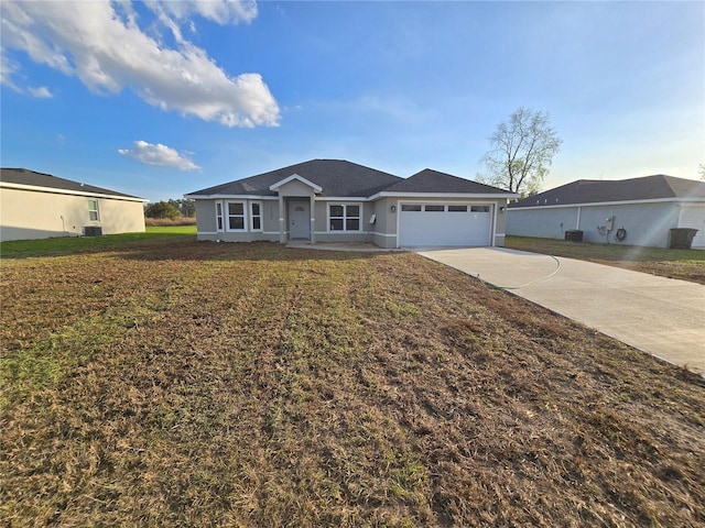 ranch-style home with a garage and a front lawn