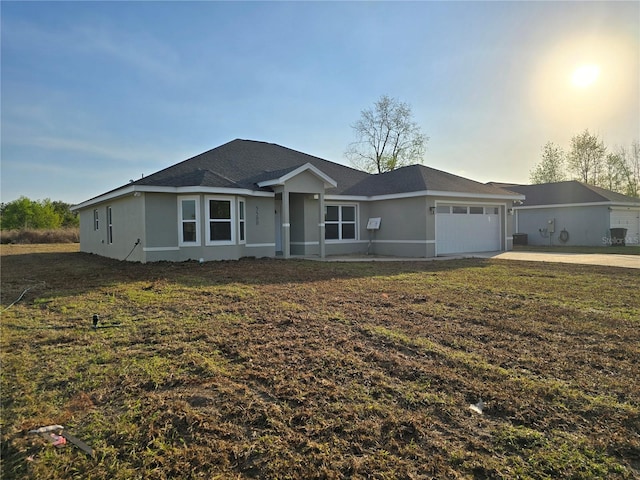 ranch-style house featuring a garage, a front lawn, concrete driveway, and stucco siding