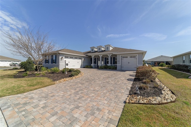 ranch-style home with a porch, a garage, and a front lawn