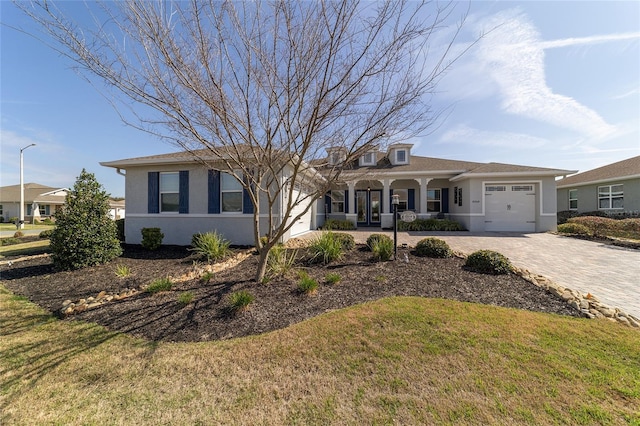 ranch-style home with a garage and a front yard