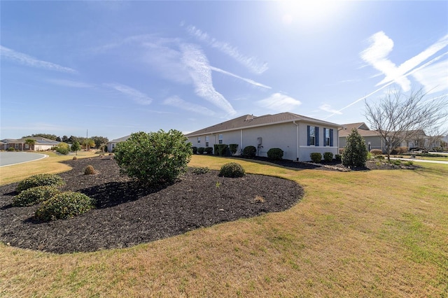 view of side of property with a yard