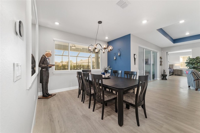 dining room with an inviting chandelier and light wood-type flooring