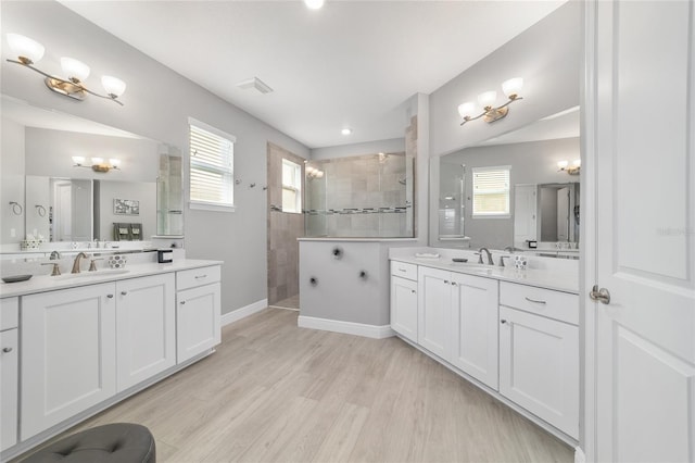 bathroom featuring vanity, hardwood / wood-style flooring, and tiled shower