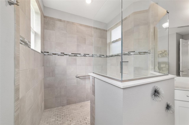 bathroom featuring vanity and tiled shower