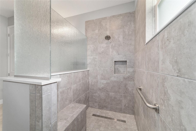 bathroom with tiled shower