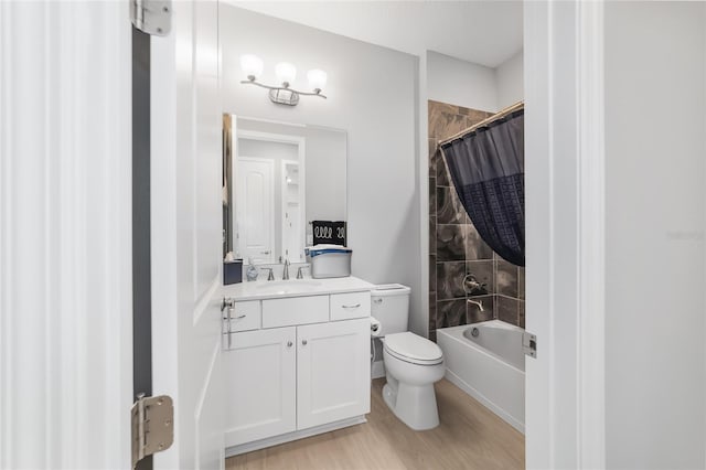 full bathroom with vanity, hardwood / wood-style flooring, toilet, and shower / tub combo with curtain