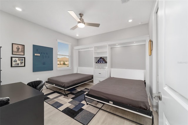 bedroom with ceiling fan and light wood-type flooring