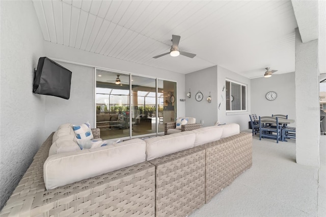 carpeted living room featuring ceiling fan