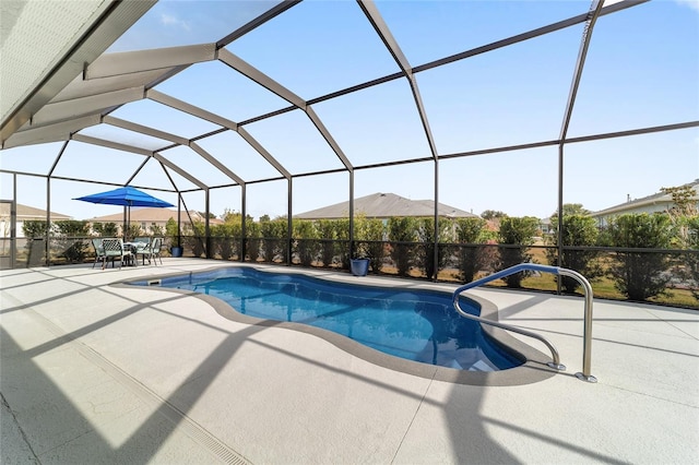 view of swimming pool featuring a patio and glass enclosure