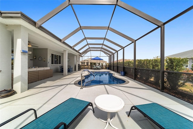 view of pool with ceiling fan, a patio, an outdoor hangout area, and glass enclosure