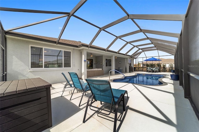 view of swimming pool with glass enclosure and a patio area