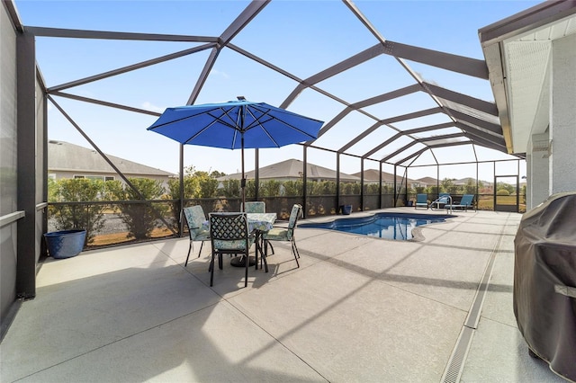 view of swimming pool featuring area for grilling, a patio, and glass enclosure