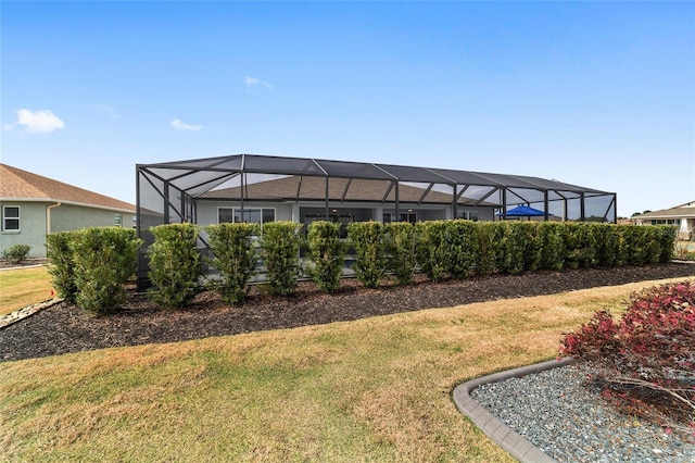 exterior space featuring a lanai and a yard