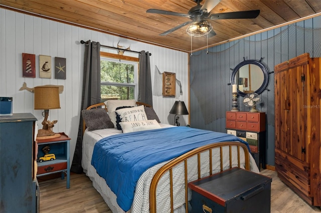 bedroom with ceiling fan, light wood-type flooring, and wood ceiling