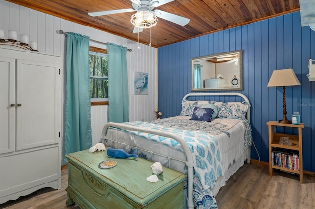 bedroom featuring hardwood / wood-style floors, wooden ceiling, and ceiling fan