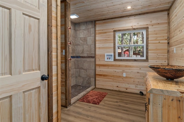 bathroom featuring wooden ceiling, hardwood / wood-style floors, and wood walls