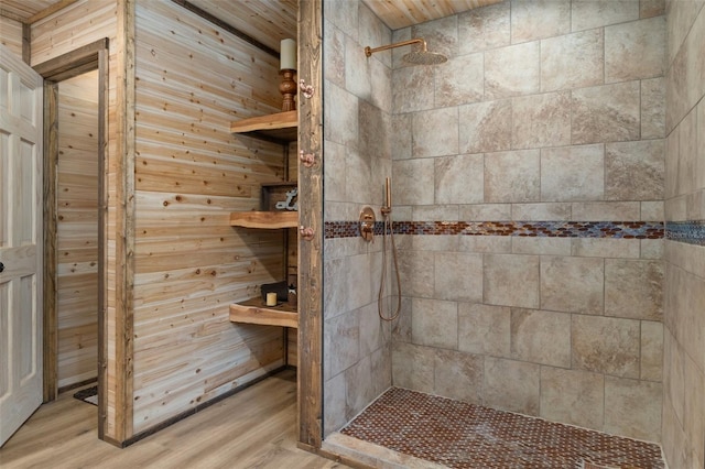 bathroom with hardwood / wood-style flooring and tiled shower