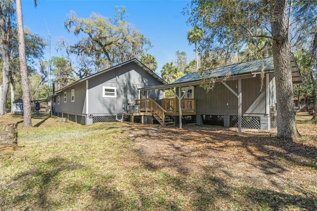 back of property featuring a yard and a deck