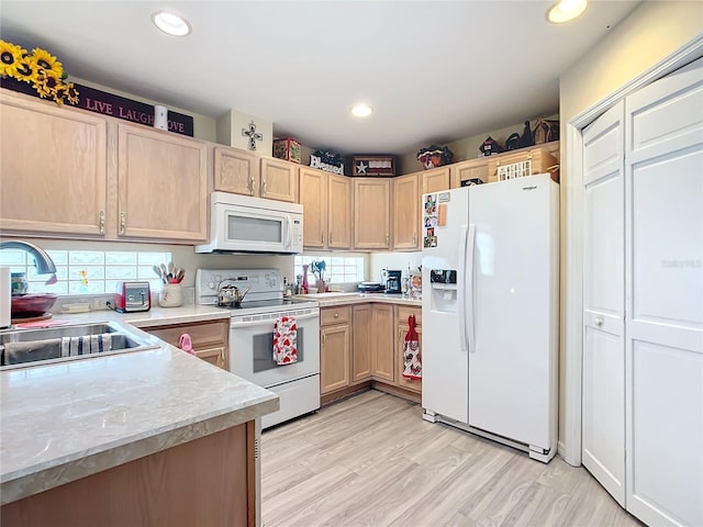 kitchen with white appliances, light hardwood / wood-style floors, sink, and light brown cabinets