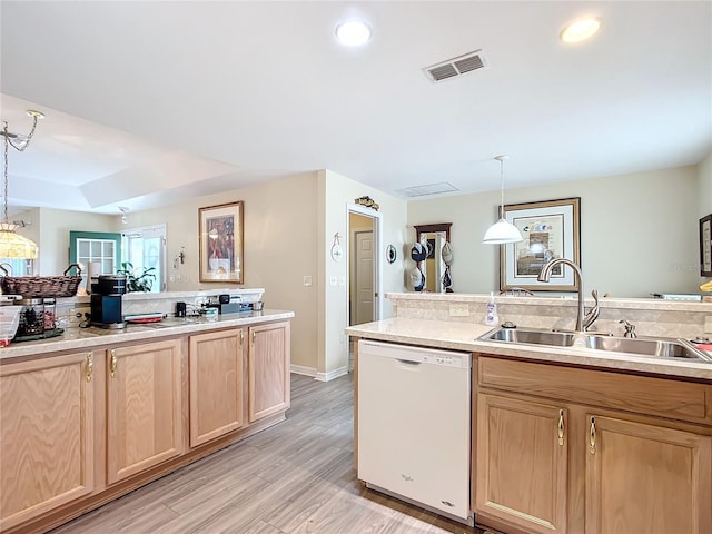 kitchen with sink, hanging light fixtures, light brown cabinets, light wood-type flooring, and white dishwasher