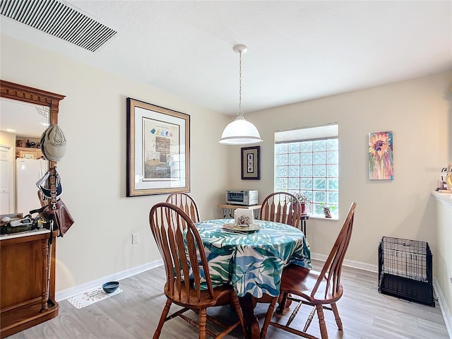 dining space featuring light hardwood / wood-style flooring