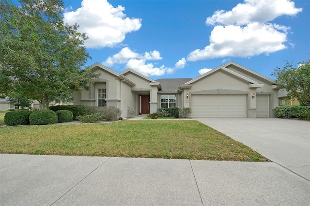 ranch-style house featuring an attached garage, a front yard, concrete driveway, and stucco siding