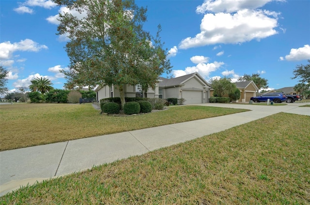 view of front of property with a front yard, driveway, and an attached garage