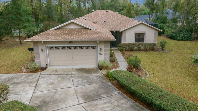 ranch-style house with stucco siding, driveway, a shingled roof, an attached garage, and a front yard