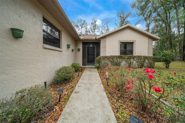 entrance to property with stucco siding