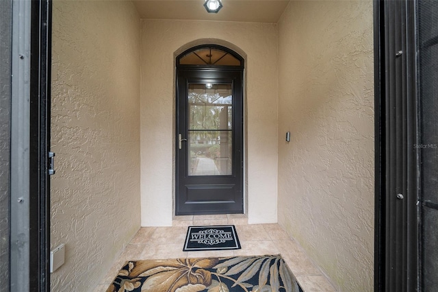 property entrance featuring stucco siding