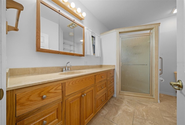 bathroom featuring a stall shower and vanity