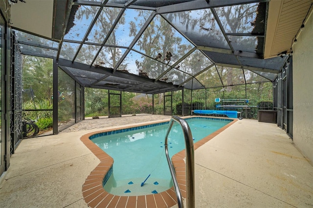 view of pool featuring a covered pool, glass enclosure, and a patio area