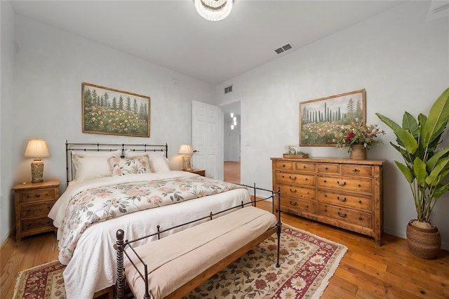 bedroom featuring visible vents and light wood finished floors