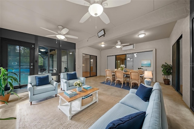 living area with a wall mounted air conditioner and concrete flooring