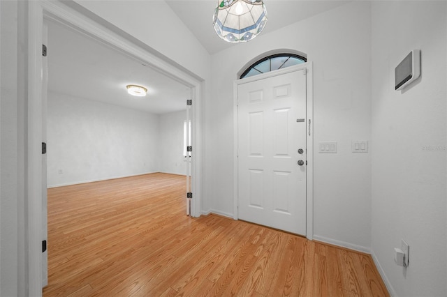 foyer with light wood finished floors and baseboards