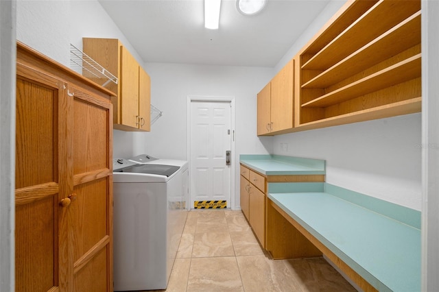 clothes washing area with cabinet space and washing machine and dryer