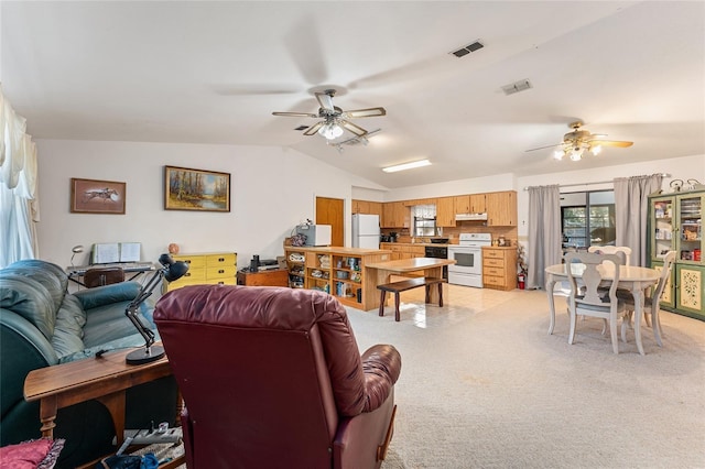 living area featuring vaulted ceiling, ceiling fan, light carpet, and visible vents