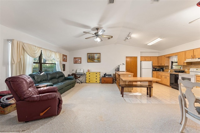 living room featuring lofted ceiling, light tile patterned floors, light colored carpet, visible vents, and a ceiling fan