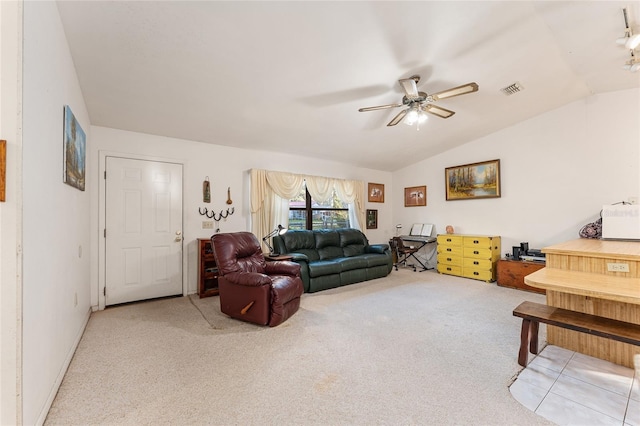 living area featuring a ceiling fan, lofted ceiling, visible vents, and carpet flooring