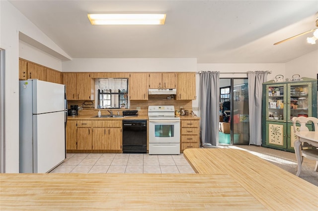 kitchen featuring light tile patterned flooring, under cabinet range hood, white appliances, a sink, and light countertops