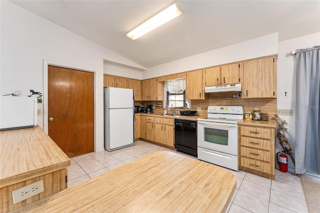 kitchen with white appliances, under cabinet range hood, light countertops, and light tile patterned flooring