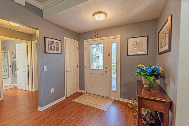 foyer with hardwood / wood-style flooring and a textured ceiling