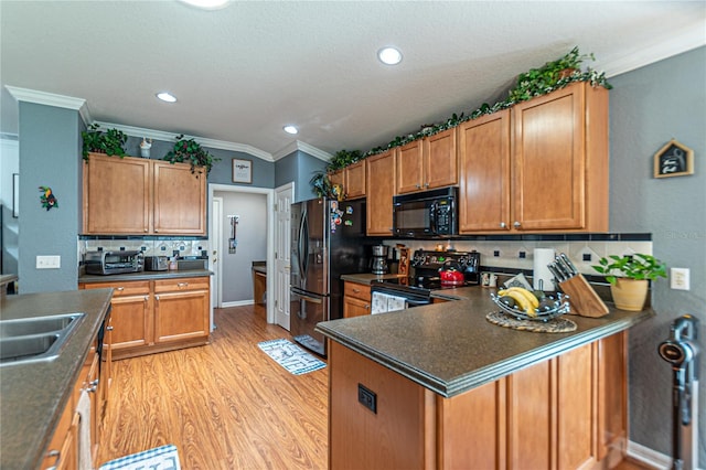 kitchen featuring black appliances, light hardwood / wood-style floors, sink, tasteful backsplash, and crown molding