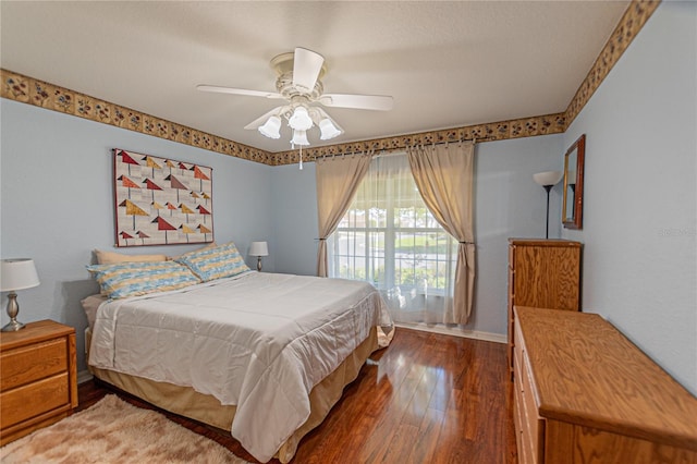 bedroom featuring ceiling fan and dark wood-type flooring