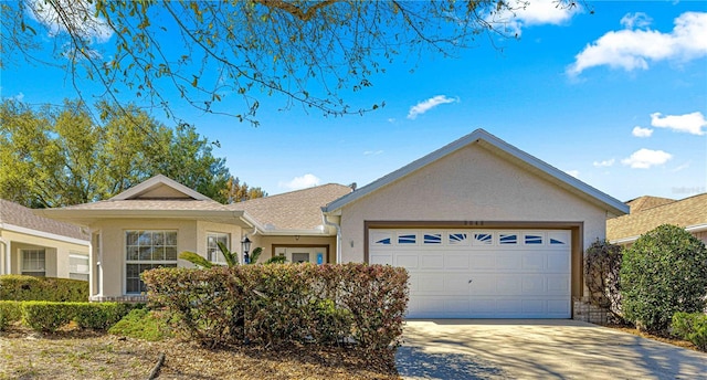 single story home featuring an attached garage, driveway, and stucco siding