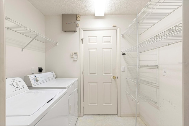 laundry room featuring laundry area, washer and dryer, and a textured ceiling