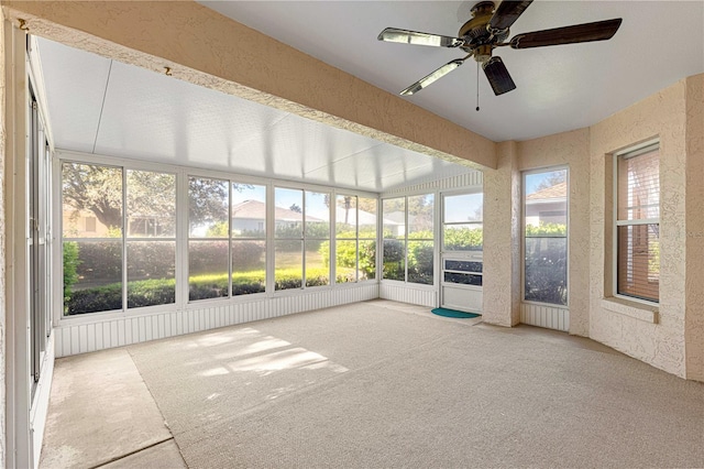 unfurnished sunroom with ceiling fan