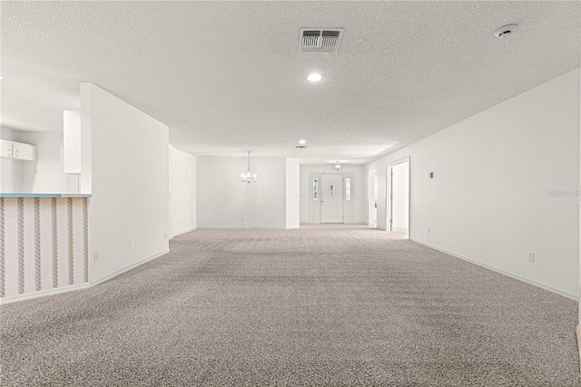 empty room with visible vents, baseboards, carpet flooring, recessed lighting, and a textured ceiling