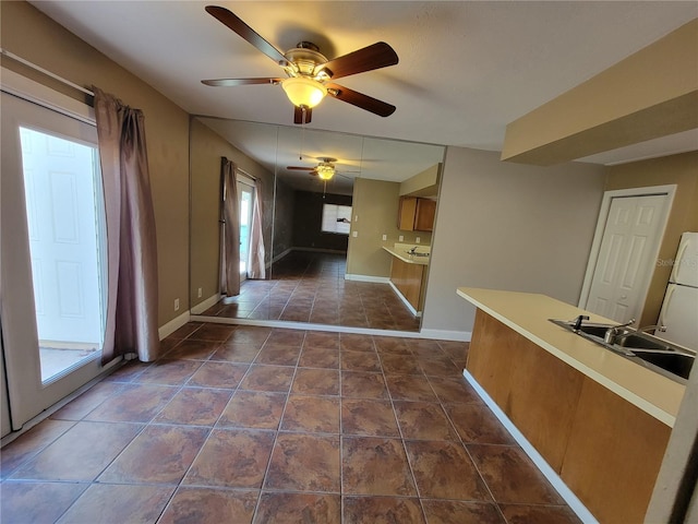 interior space with sink and ceiling fan