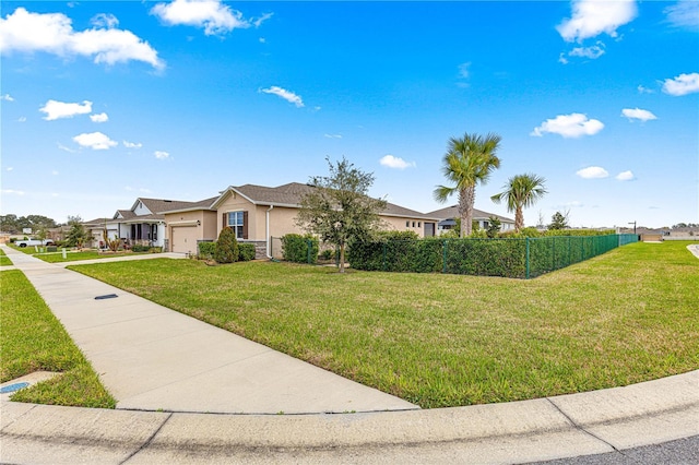 single story home featuring a front lawn and a garage